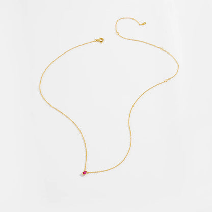 Gold necklace with a pear-shaped pink gemstone pendant at the center.

