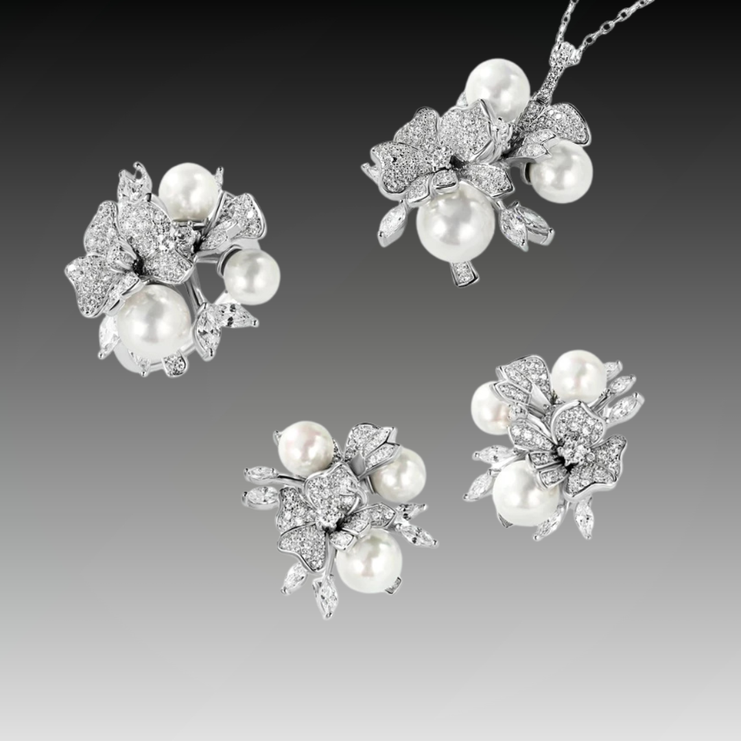Jewellery set with white pearls and pavé floral details including earrings, brooch and pendant

