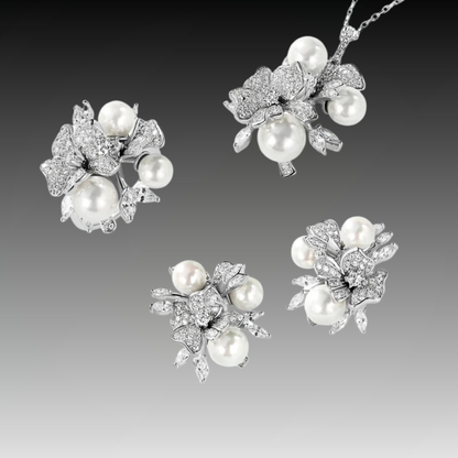 Jewellery set with white pearls and pavé floral details including earrings, brooch and pendant

