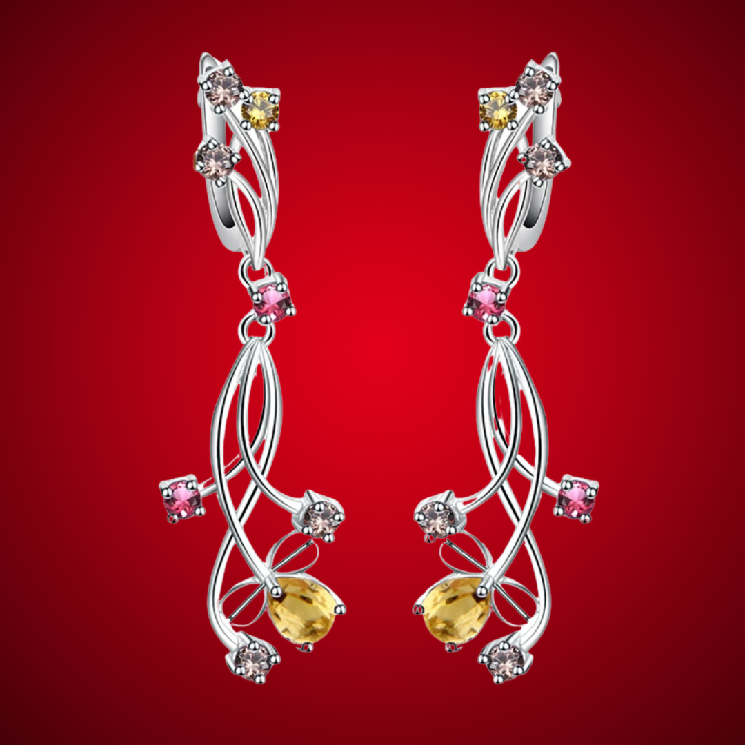 Pair of silver drop earrings with yellow teardrop stones and mixed round gemstones in pink, champagne, and yellow tones.

