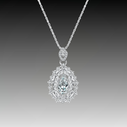 Ornate silver necklace with an intricate teardrop pendant, featuring a central pear-cut white gemstone, part of the Bianco Nero collection.

