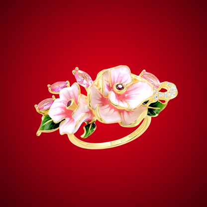 Prato ring with hand-painted pink flowers, green enamel leaves, and pink marquise-cut stones on a gold band.

