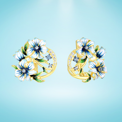 Gold-tone earrings with white and blue enamel flowers and crystal accents

