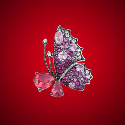 Butterfly ring with sculpted wings in pink and fuchsia gemstones and teardrop-shaped stones forming the body.

