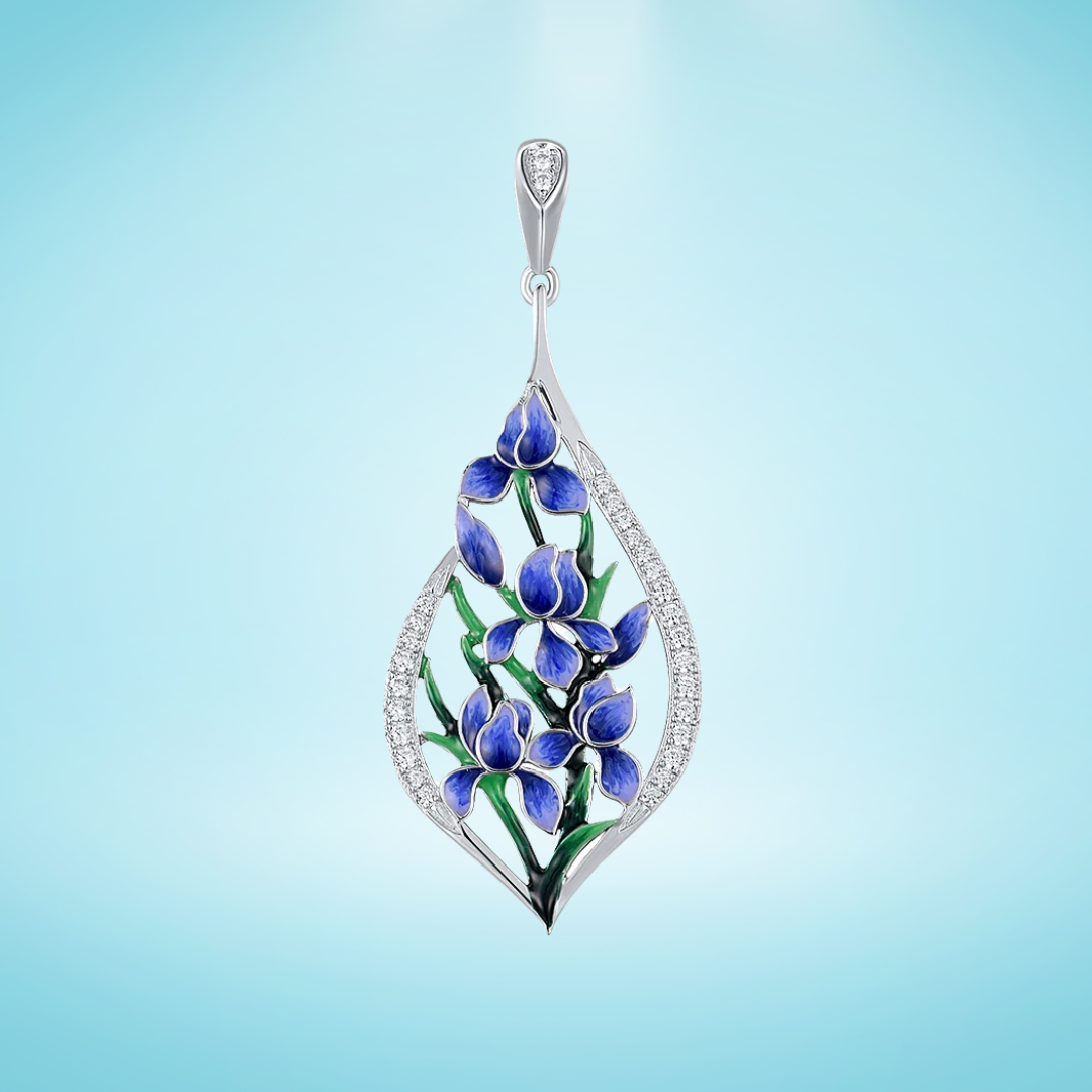 Silver pendant featuring blue and violet enamel flowers with green leaves, framed by a teardrop of pavé stones

