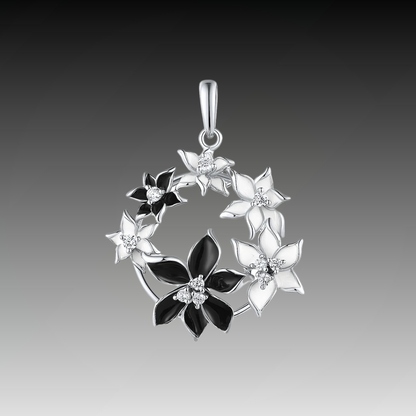 Pendant with alternating black and white floral elements arranged in a circular wreath

