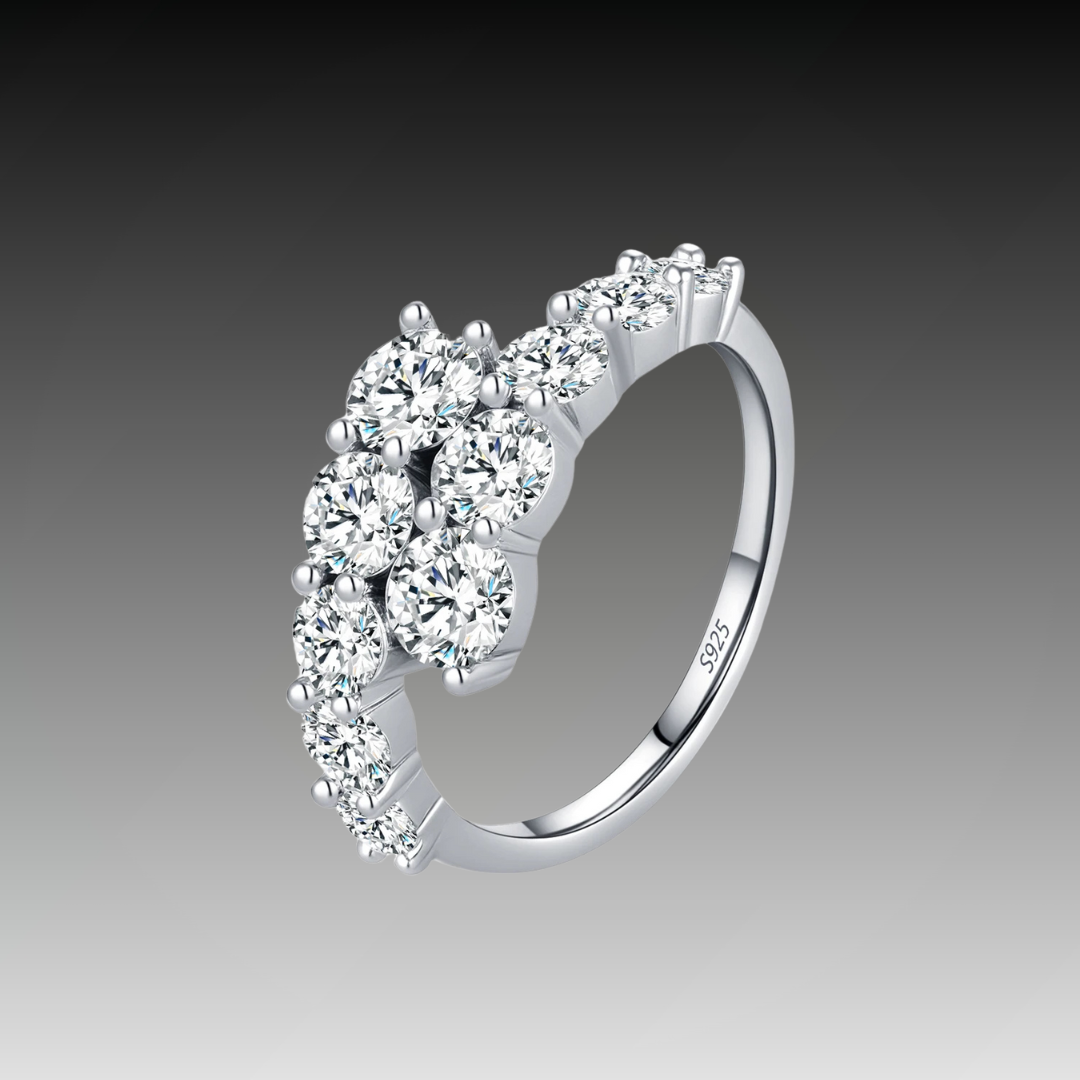 Sterling silver ring with a diagonal cluster of brilliant white round-cut stones in a cascading arrangement

