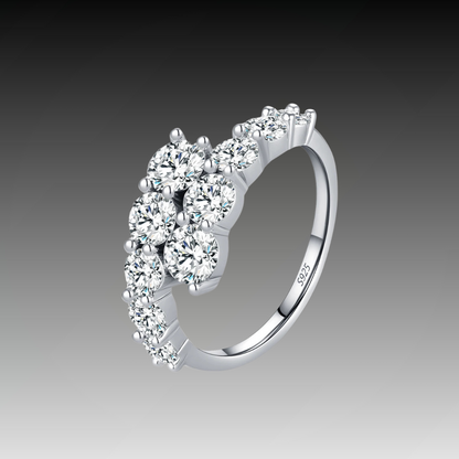 Sterling silver ring with a diagonal cluster of brilliant white round-cut stones in a cascading arrangement

