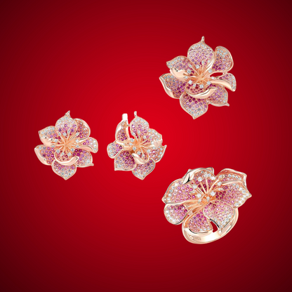 Fragola jewelry set featuring pink and violet pavé stones in rose gold flower designs including ring, earrings, and pendant.

