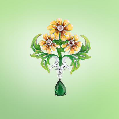 Brooch with three yellow enamel flowers, green enamel leaves, and a dangling green teardrop gemstone

