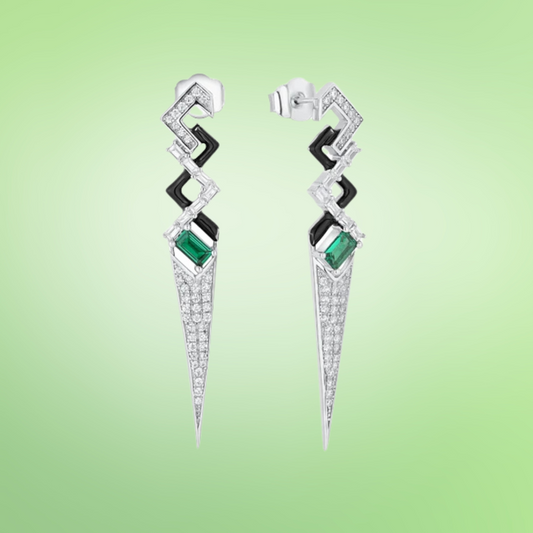 Long silver drop earrings with geometric shapes, black enamel accents, and green baguette-cut stones

