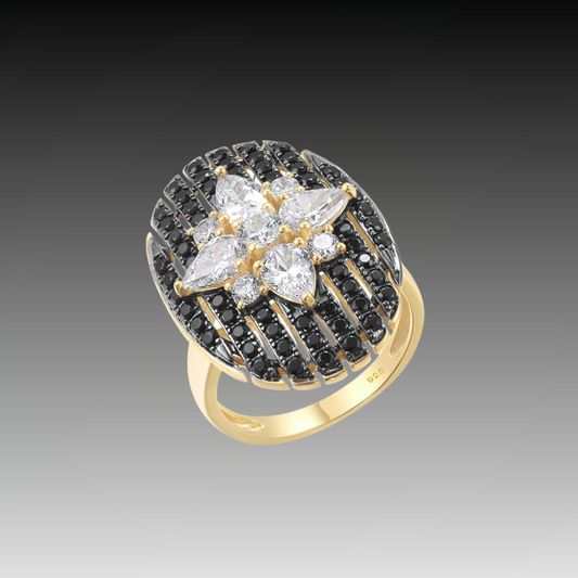 Gold ring with an oval black and white starburst design featuring clear marquise and round stones

