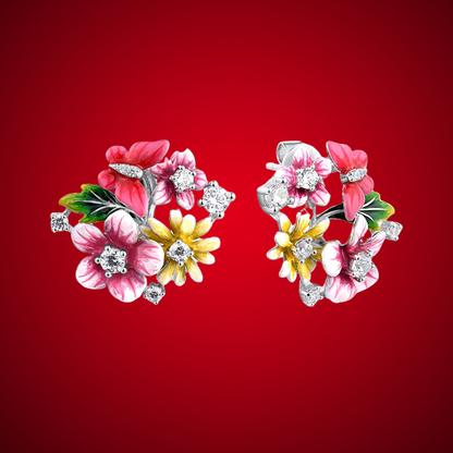Pair of vibrant floral stud earrings with pink, red, and yellow enamel flowers accented by sparkling stones, set against a red background.

