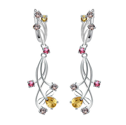 Pair of silver drop earrings with yellow teardrop stones and mixed round gemstones in pink, champagne, and yellow tones.

