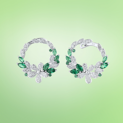 Silver and green gemstone hoop earrings with floral clover-inspired accents

