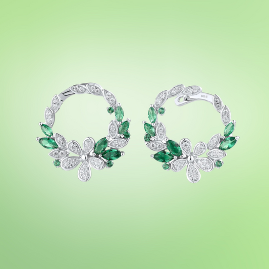 Silver and green gemstone hoop earrings with floral clover-inspired accents

