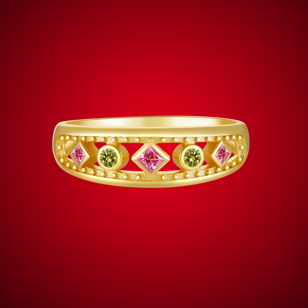 Gold ring with alternating pink square-cut and green round gemstones, framed by beaded detailing, displayed on a red background.

