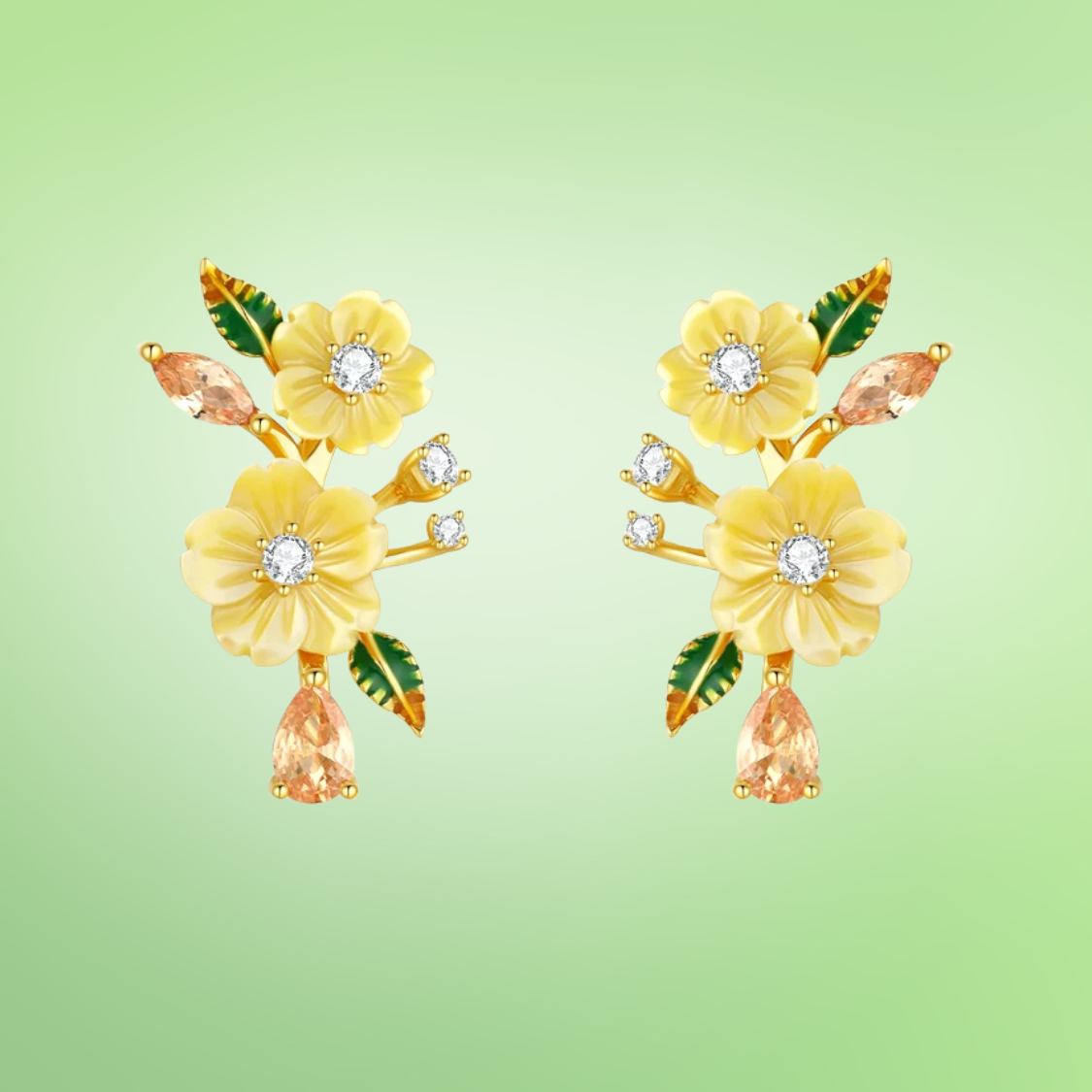 Yellow floral earrings with gemstone drops and green enamel leaves on gold setting

