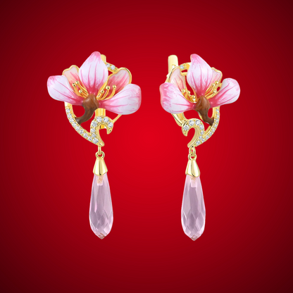 Lampadario earrings with pink enamel flower tops, gold detailing, and faceted pink teardrop dangles.

