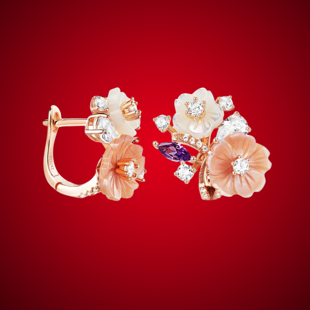 Begonia floral earrings with carved peach and ivory petals, accented by sparkling white and violet stones in a rose gold setting.

