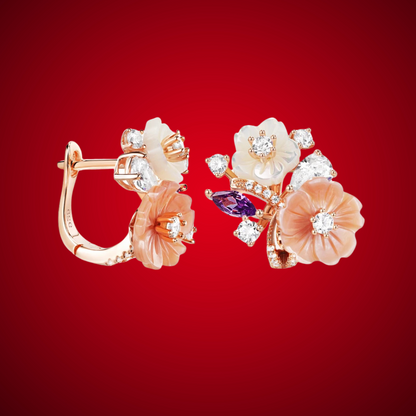 Begonia floral earrings with carved peach and ivory petals, accented by sparkling white and violet stones in a rose gold setting.

