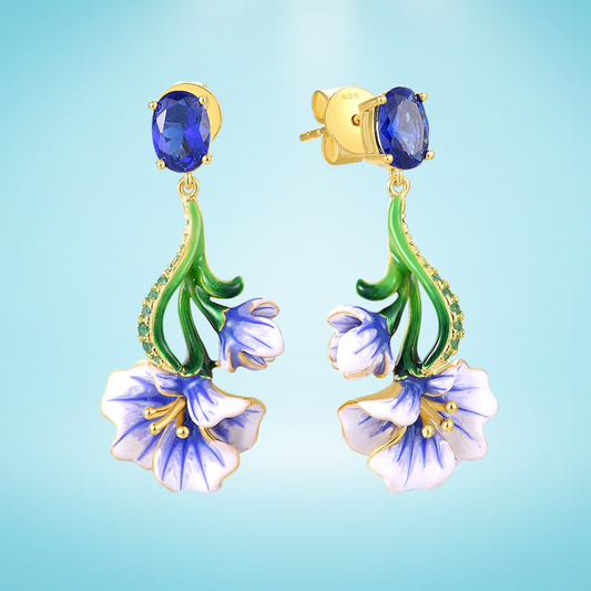 Gold-plated silver drop earrings with blue enamel Scilla flowers and oval sapphire-colored stones

