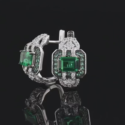 Octagonal silver earrings with emerald-cut green center stones, haloed by smaller green and clear stones

