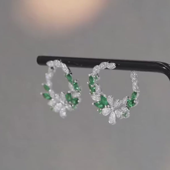 Silver and green gemstone hoop earrings with floral clover-inspired accents

