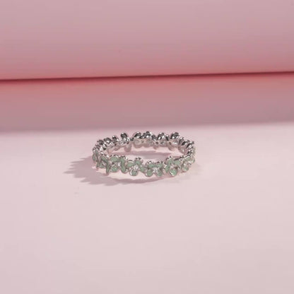 Sterling silver floral band ring with light green enamel petals and tiny diamond accents.

