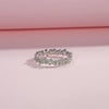 Sterling silver floral band ring with light green enamel petals and tiny diamond accents.

