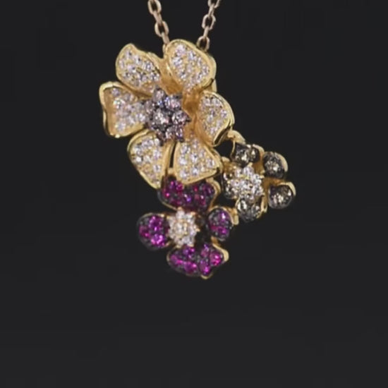 Clustered flower-shaped pendant with white, pink, red, and black pavé stones in gold-toned settings


