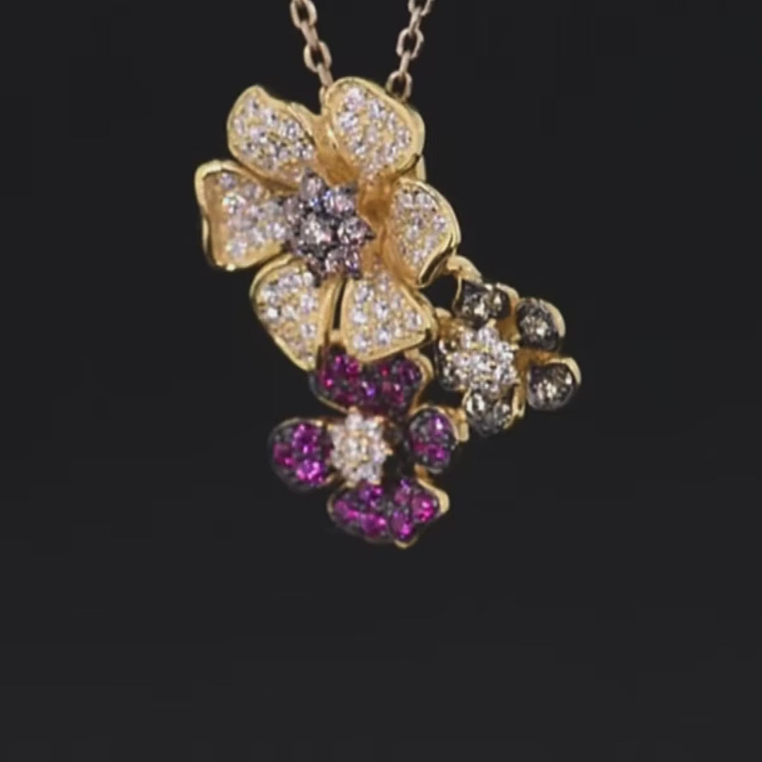 Clustered flower-shaped pendant with white, pink, red, and black pavé stones in gold-toned settings


