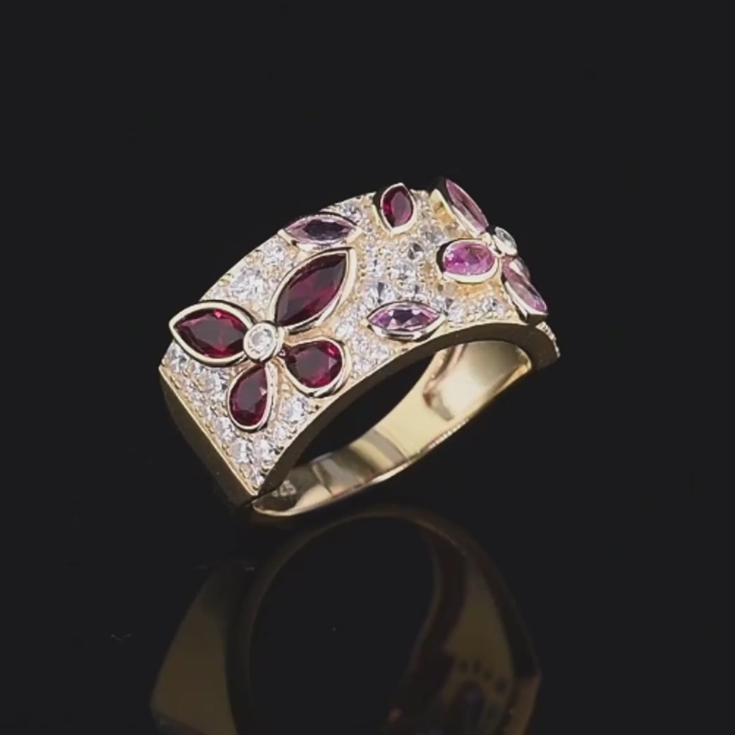Gold ring set with marquise-cut pink and red stones forming floral patterns, Rosea from the Rossa Collection.

