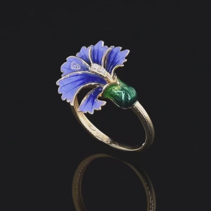 Gold ring with a violet enamel flower and green enamel bud, accented with small clear stones

