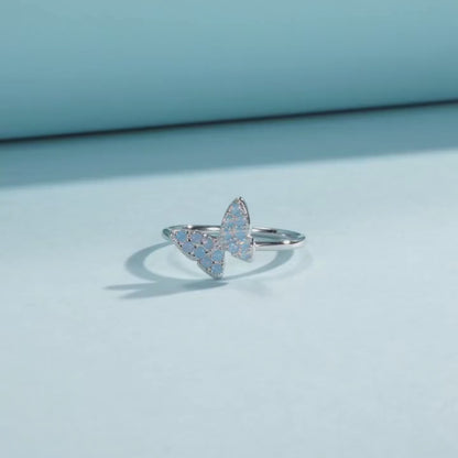Sterling silver ring with a delicate butterfly shape inlaid with shimmering opal stones

