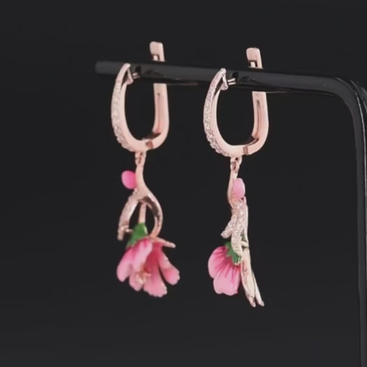 Fiore Pressato earrings shaped like delicate pink bell flowers, accented with green and gold enamel and sparkling stones.

