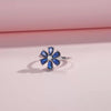 Sterling silver ring with a royal blue gemstone flower and clear stone center

