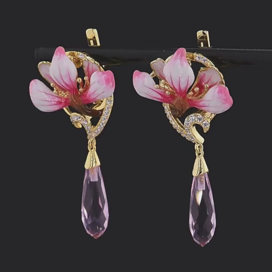Lampadario earrings with pink enamel flower tops, gold detailing, and faceted pink teardrop dangles.

