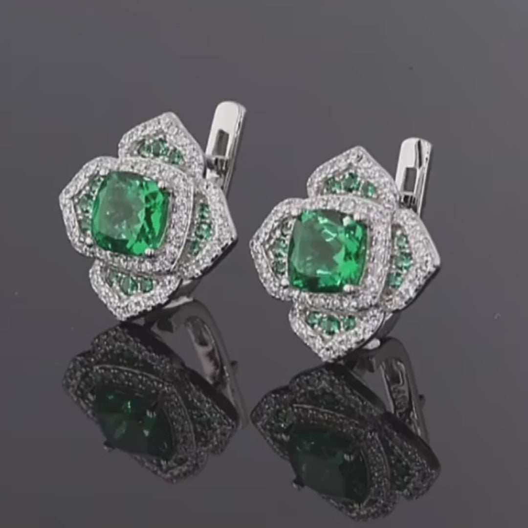 Cushion-cut green gemstone earrings with layered silver and green pavé accents

