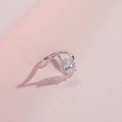 Open silver ring with a triangular wrap design, featuring a prominent oval white stone at its center, from the Bianco Nero collection.

