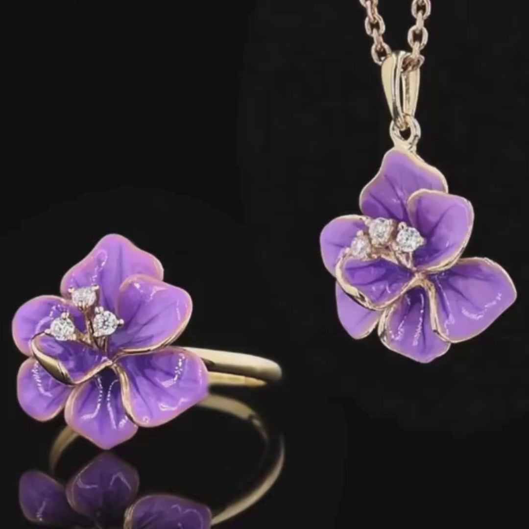 Gold floral jewelry set with violet enamel flowers and crystal accents, including earrings, pendant, and ring

