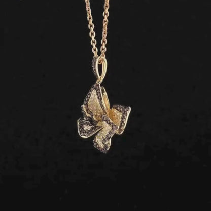 Pendant shaped like a layered flower with brown and white pavé stones on gold-toned metal

