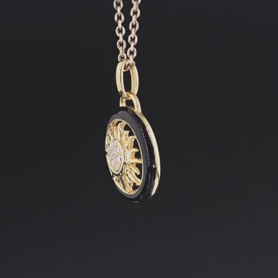 Gold and black circular sun pendant with clear stones at the center, titled Solis Oro.

