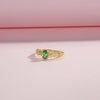 Gold-plated silver ring with a green oval gemstone and delicate diamond-accented detailing.

