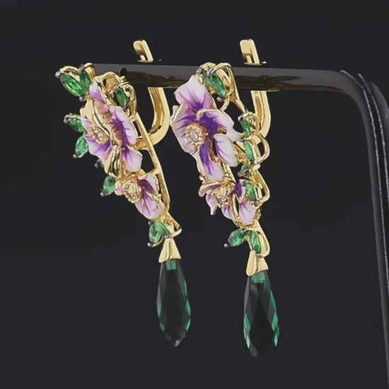 Gold earrings with purple enamel flowers, green marquise leaves, and elongated dark green crystal drops

