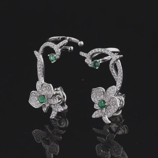 Floral vine-inspired earrings with sparkling white pavé and green gemstone accents

