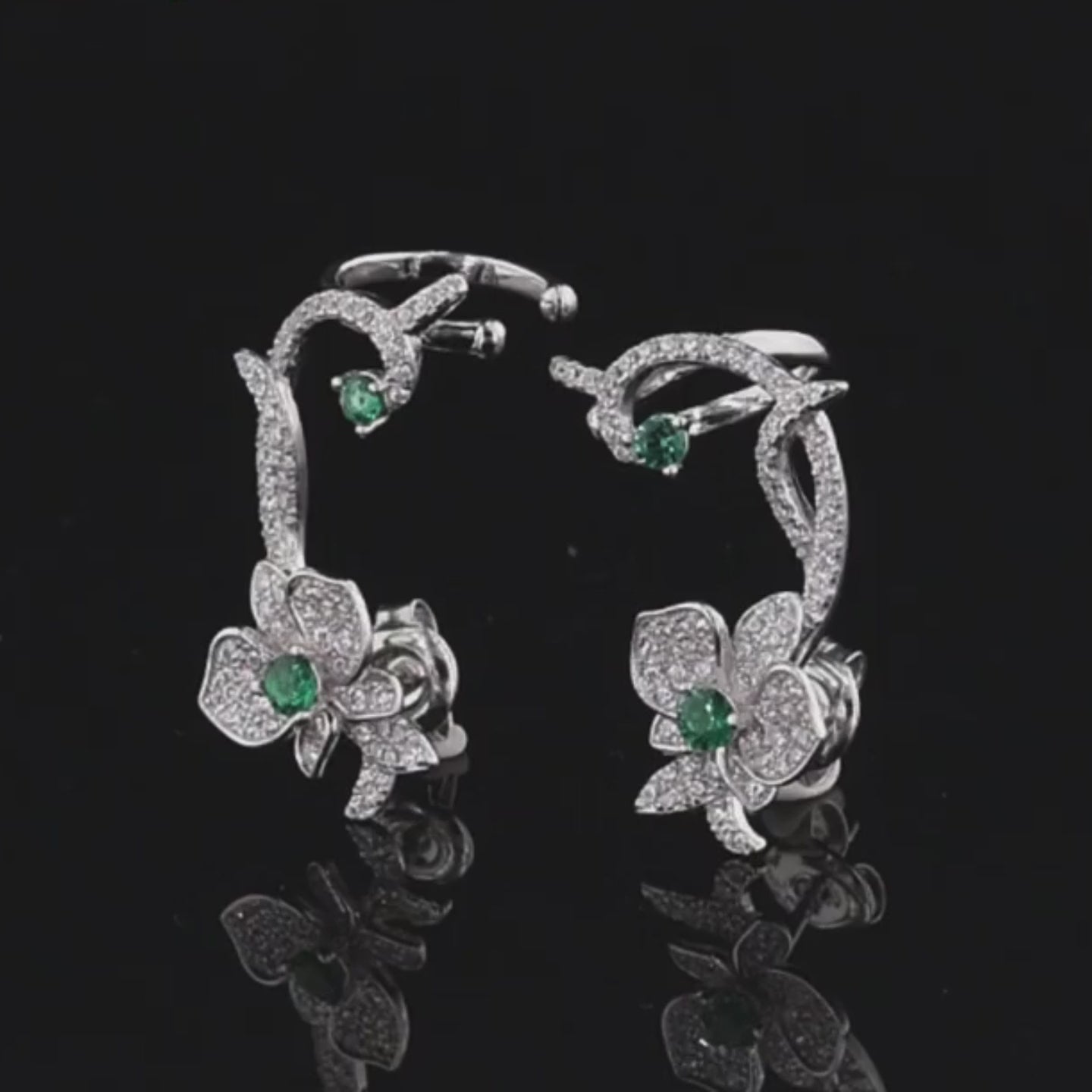 Floral vine-inspired earrings with sparkling white pavé and green gemstone accents

