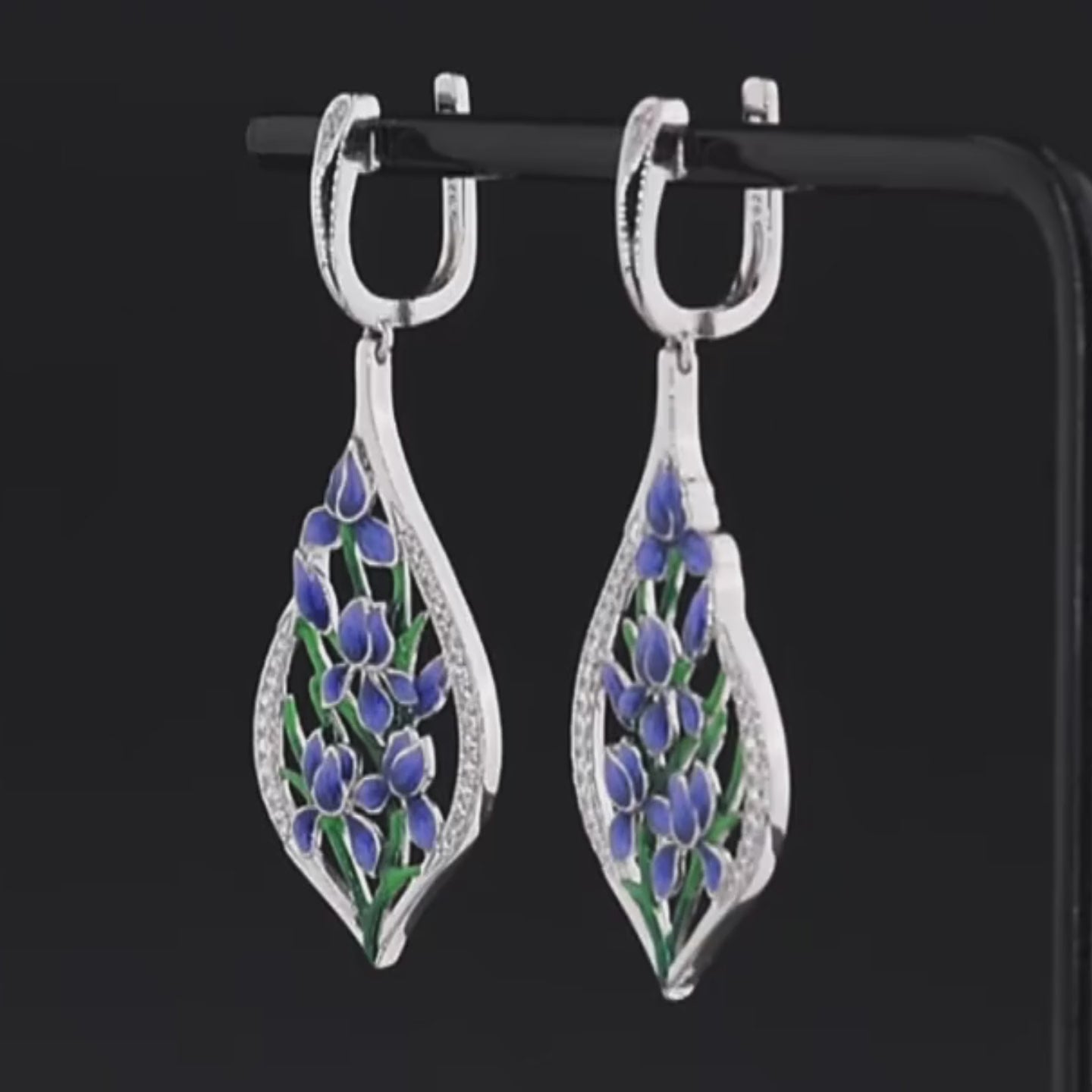 Sterling silver drop earrings featuring blue and green enamel floral vines framed in teardrop-shaped pavé-set silver 

