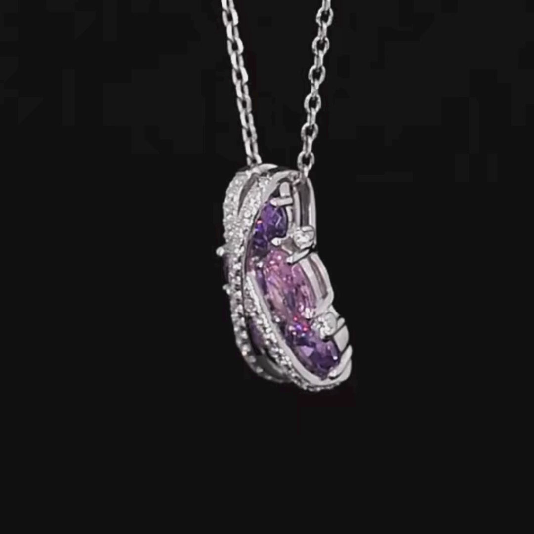 Ring featuring overlapping pavé crystal bands over clustered purple and pink gemstones in various cuts.

