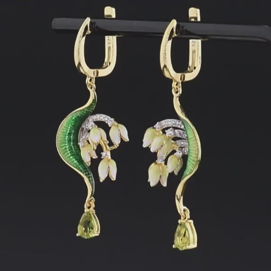 Gold drop earrings with curved green enamel leaves and cascading pink floral buds accented by pavé stones and teardrop gems

